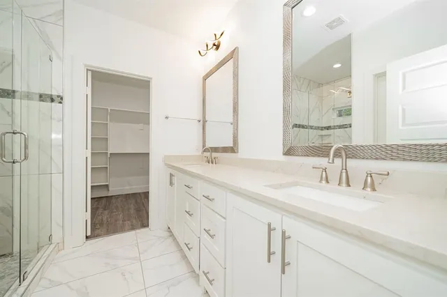a bathroom with a double vanity sink and a mirror