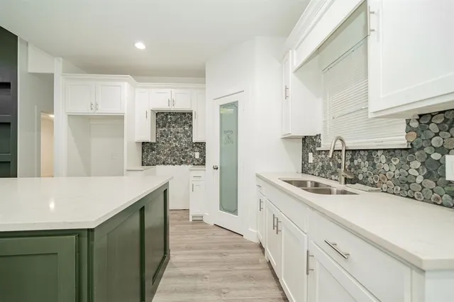 a kitchen with a sink stove and cabinets