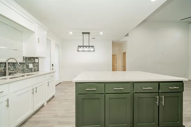 a kitchen with stainless steel appliances a sink and cabinets