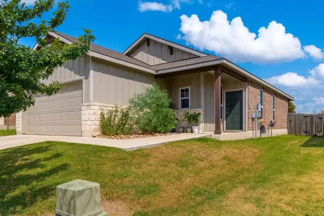 a front view of a house with a yard