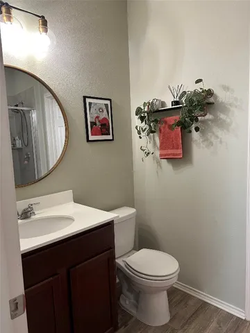 a bathroom with a toilet a sink and mirror