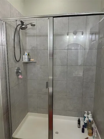 a bathroom with a shower and a bathtub