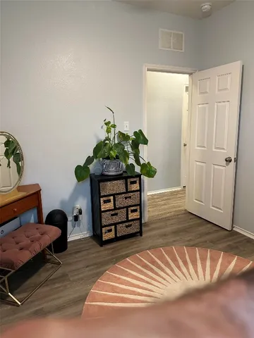 a bedroom with furniture and a potted plant