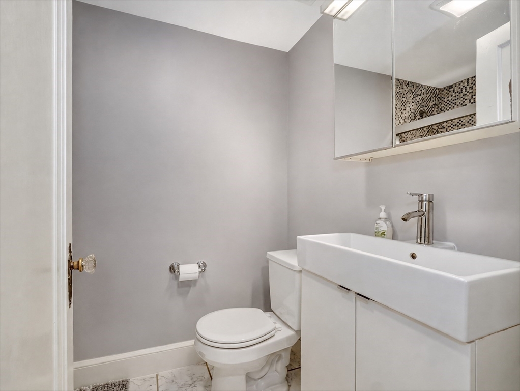 87 Payson Road Brookline, MA 02467 - Photo 18 of 41 a bathroom with a sink a toilet and mirror