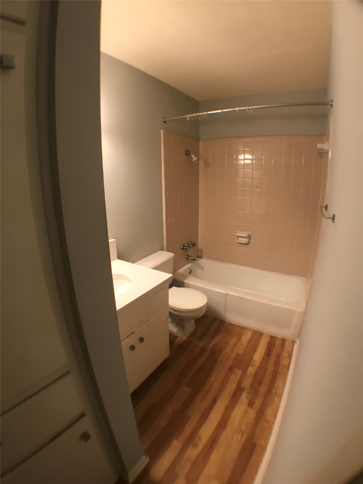 5001 Bull Creek Road, Unit 111 Austin, TX 78731 - Photo 6 of 11 A compact bath featuring a tub and shower, alongside a neat vanity with ample storage.