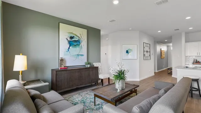 a kitchen with stainless steel appliances kitchen island granite countertop a refrigerator a stove and white cabinets