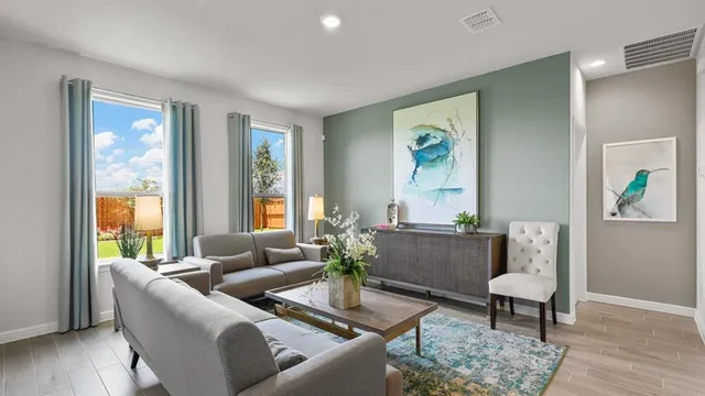a kitchen with a dining table chairs and refrigerator