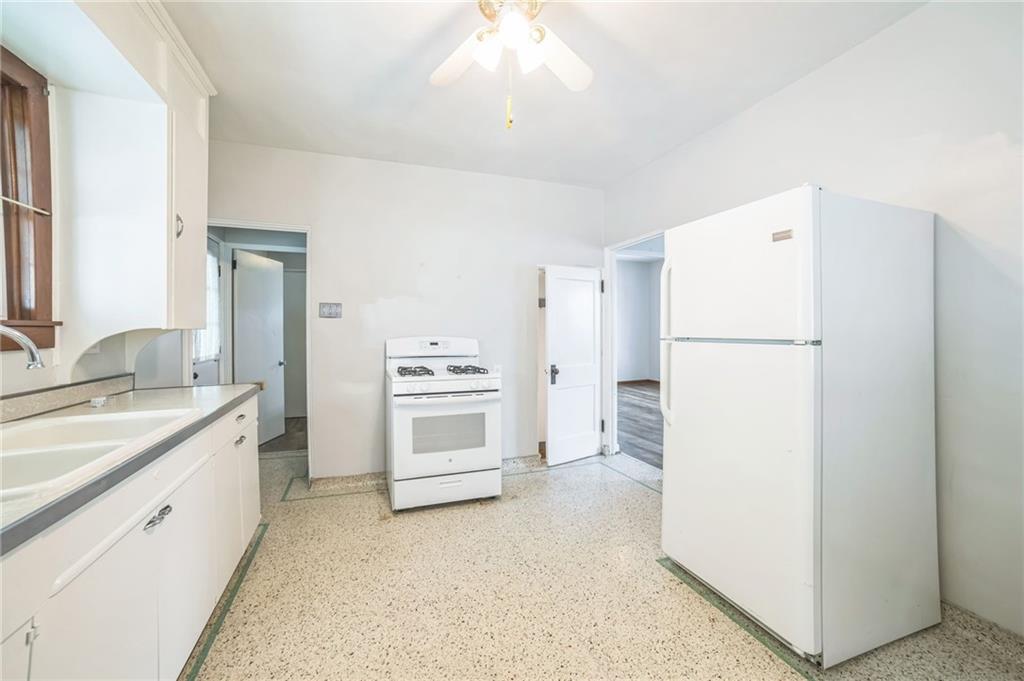 504 1st Street Charleroi, PA 15022 - Photo 9 of 18 a kitchen with a refrigerator a stove and a sink