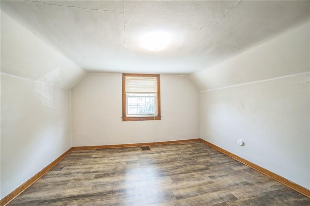 504 1st Street Charleroi, PA 15022 - Photo 10 of 18 an empty room with wooden floor and windows