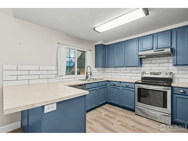 a kitchen with a sink stove and cabinets