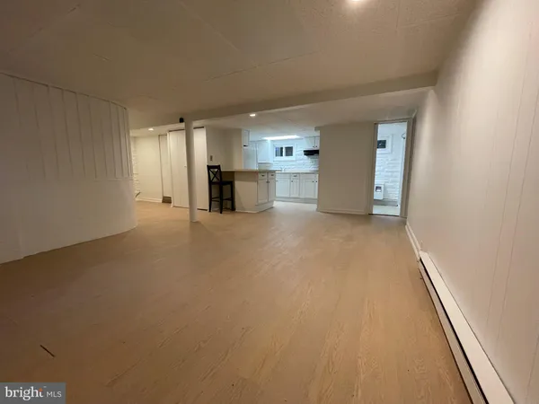 a view of a kitchen with a sink and a refrigerator