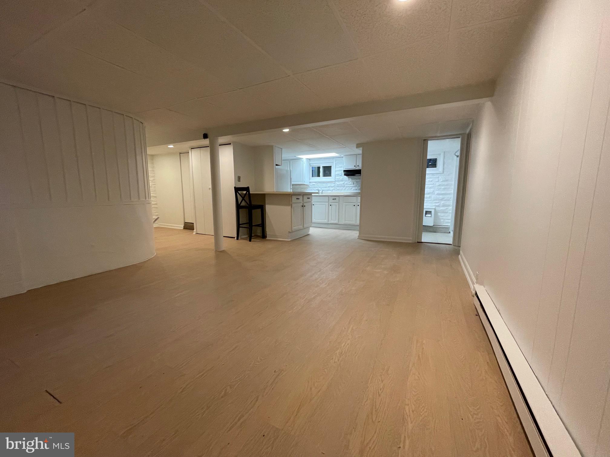a view of a kitchen with a sink and a refrigerator