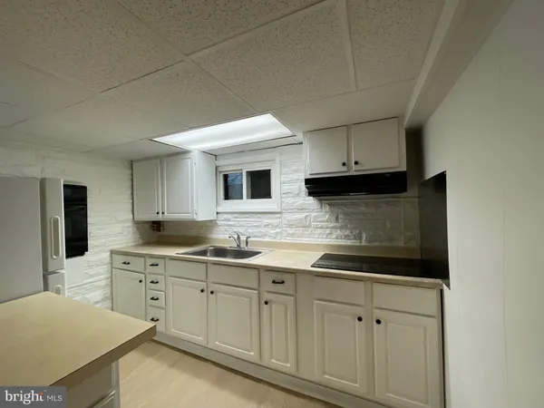 a kitchen with a refrigerator and a sink