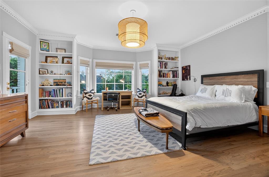 6331 Waggoner Drive Dallas, TX 75230 - Photo 23 of 36 a bedroom with a bed a table and large windows