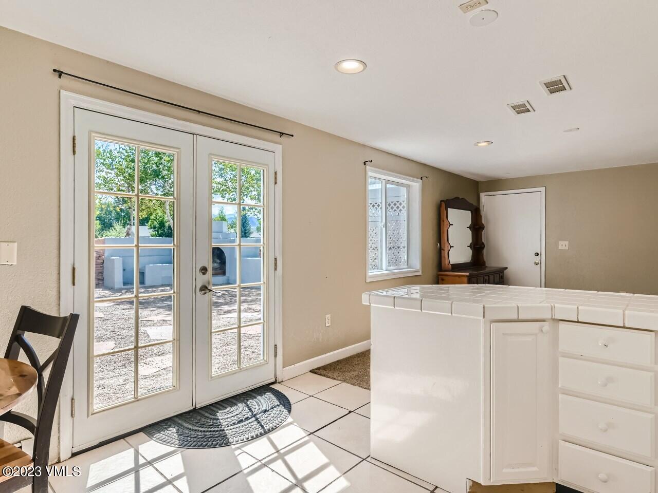 25 Snow Owl Eagle, CO 81631 - Photo 17 of 37 a kitchen with white cabinets and outdoor space