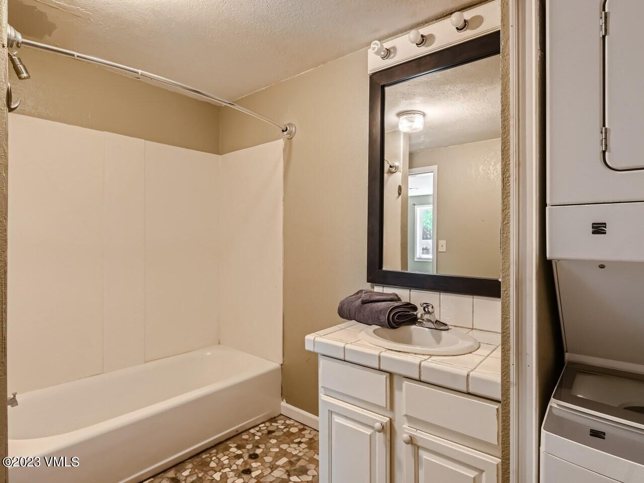 25 Snow Owl Eagle, CO 81631 - Photo 21 of 37 a bathroom with a granite countertop sink a toilet and shower