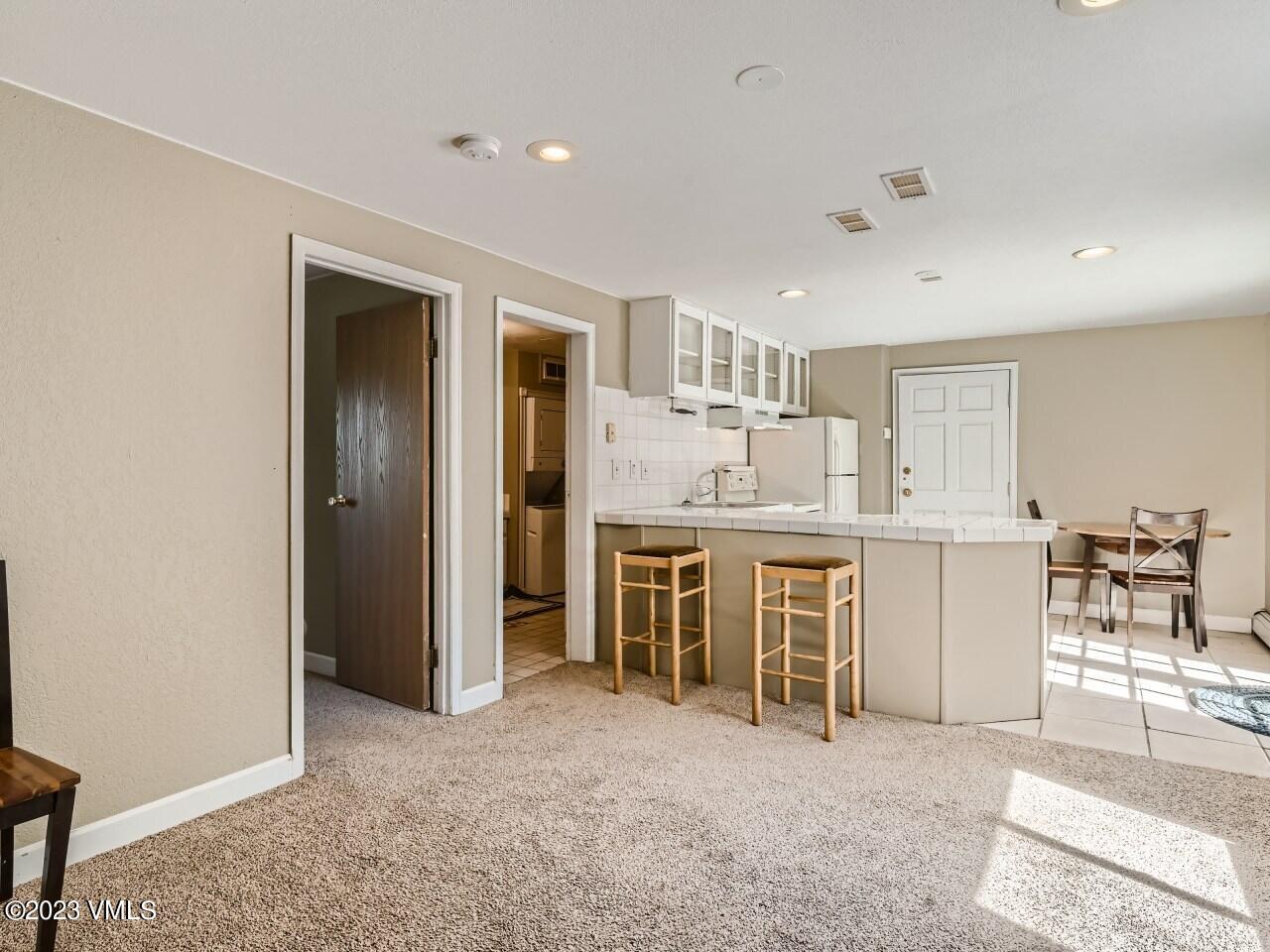 25 Snow Owl Eagle, CO 81631 - Photo 22 of 37 a kitchen with stainless steel appliances kitchen island granite countertop a refrigerator and cabinets