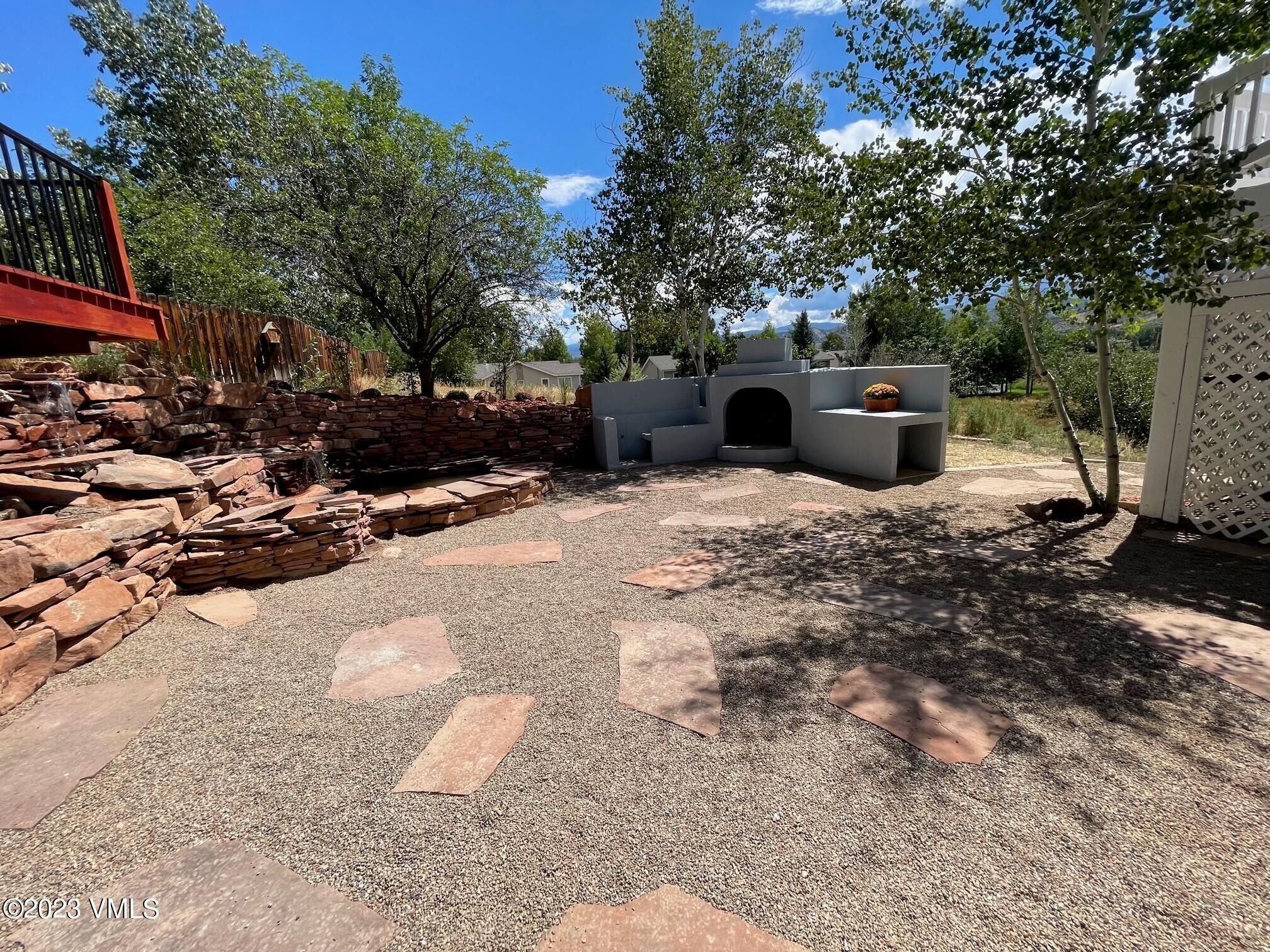 25 Snow Owl Eagle, CO 81631 - Photo 29 of 37 a view of a patio with table and chairs potted plants and large tree