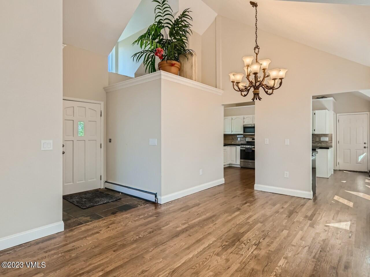 25 Snow Owl Eagle, CO 81631 - Photo 6 of 37 a view of a livingroom with a chandelier wooden floor and a kitchen