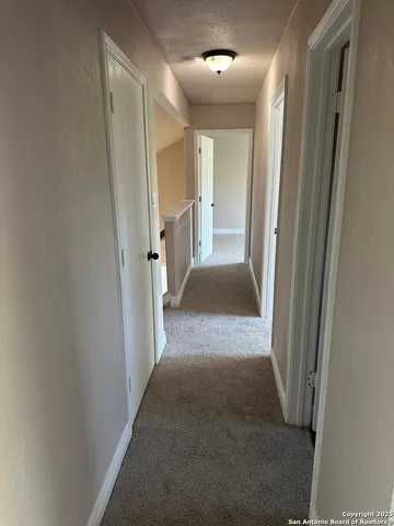 a view of a hallway to a bedroom