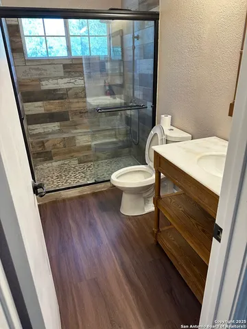 a bathroom with a toilet and a shower