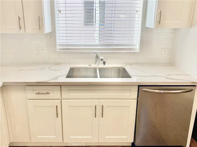 a kitchen with stainless steel appliances a stove a sink and a refrigerator