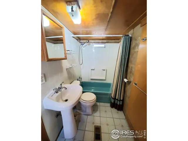 a bathroom with a sink toilet and mirror