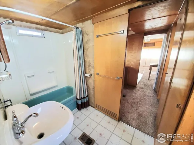 a bathroom with a tub and a shower
