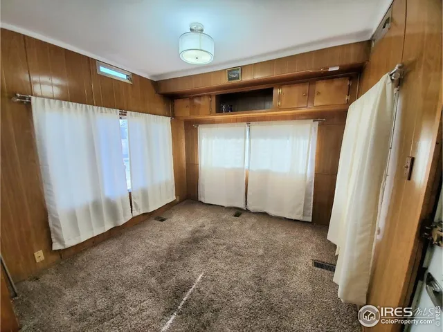 a view of empty room with wooden walls