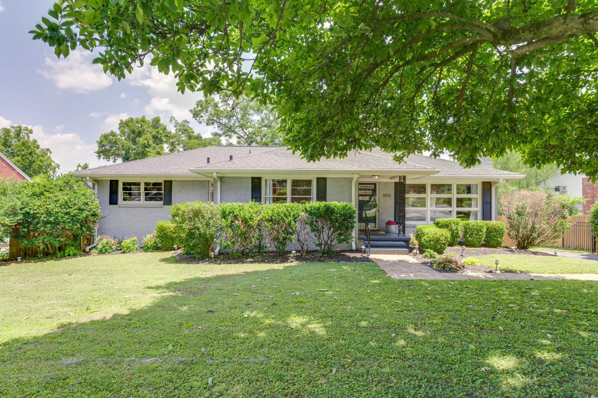 3512 Pleasant Valley Road Nashville, TN 37204 - Photo 1 of 40 a front view of a house with a yard table and chairs