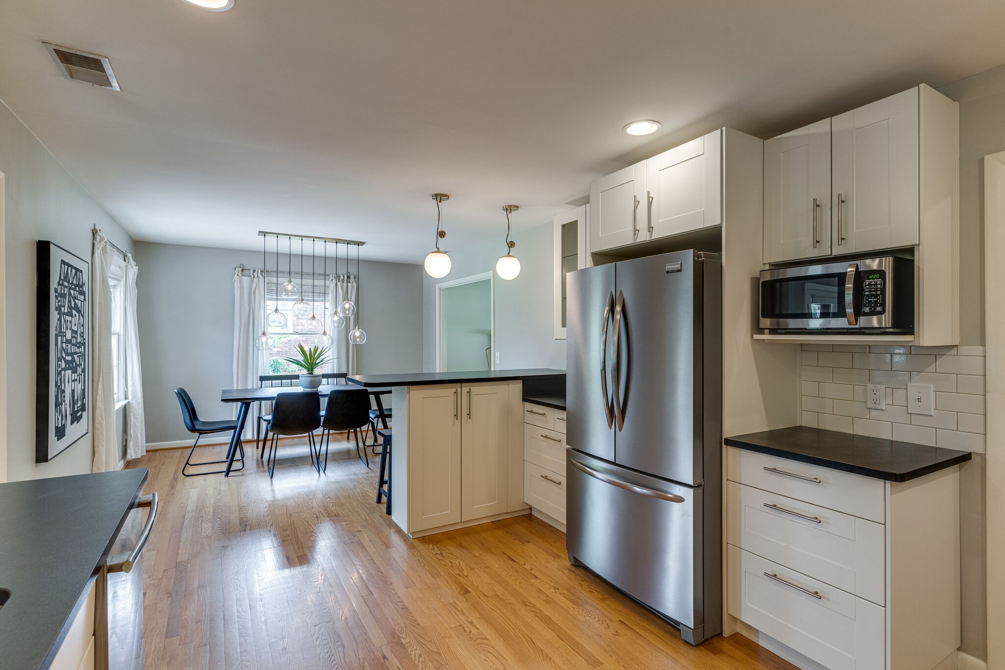 3512 Pleasant Valley Road Nashville, TN 37204 - Photo 12 of 40 a kitchen with stainless steel appliances a refrigerator stove microwave and cabinets