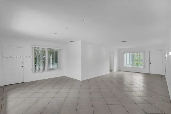 an empty room with windows and entrance