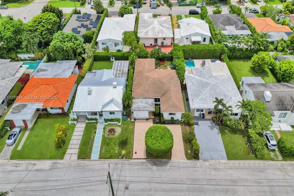 an aerial view of multiple houses with yard