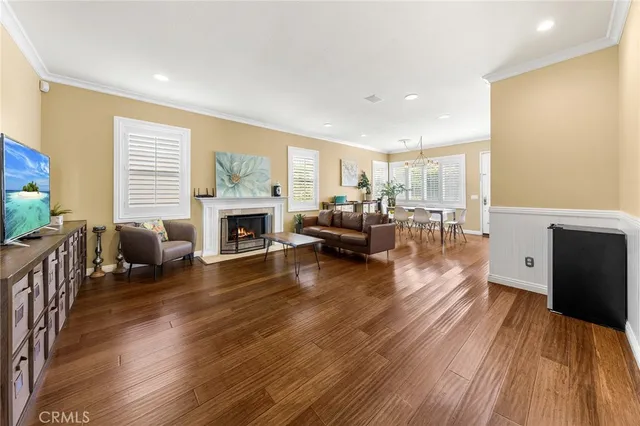 a living room with furniture wooden floor and a fireplace