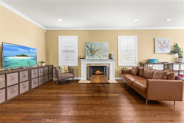 a living room with furniture a fireplace and a flat screen tv