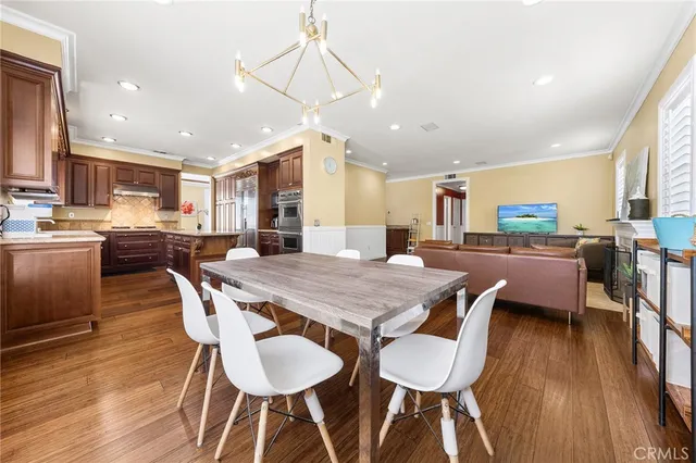 a large kitchen with a table and chairs