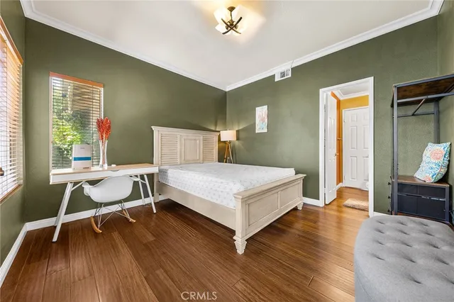 a bedroom with a bed and a desk