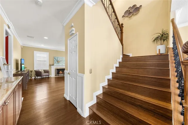 a view of entryway and hall with wooden floor