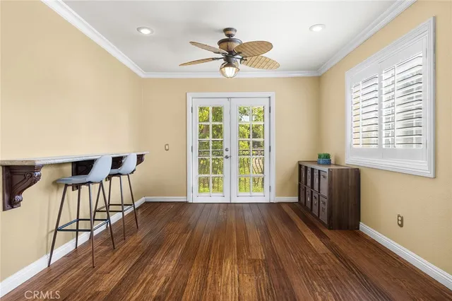 a view of a livingroom with furniture window wooden floor and a ceiling fan