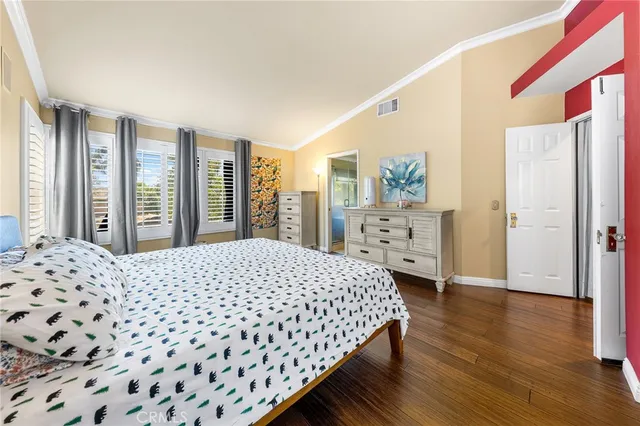 a bedroom with a large bed and a dresser