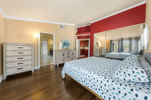 a large bedroom with a bed and a dresser