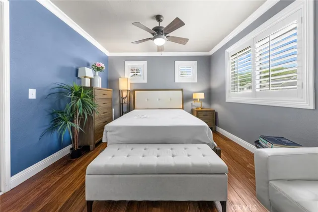 a bedroom with a bed and a potted plant