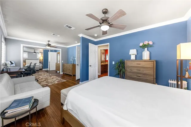 a bedroom with a bed and ceiling fan
