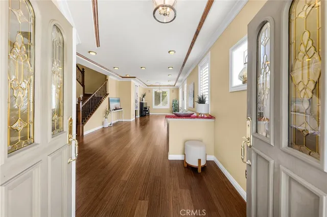 a dining room with wooden floor and entrance