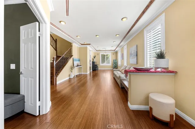 a very nice looking room with wooden floor and furniture