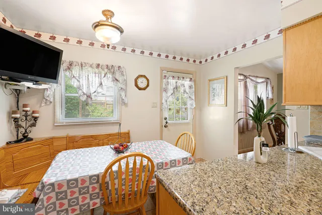 a bedroom with a bed a flat screen tv and a window