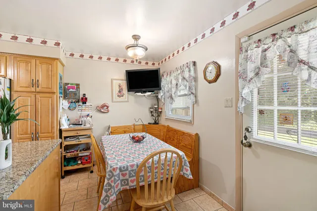 a bedroom with a bed and a flat tv screen on the dresser
