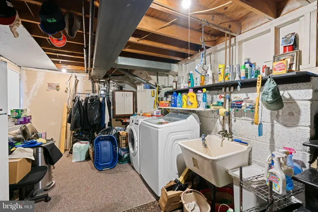 a utility room with sink dryer and washer