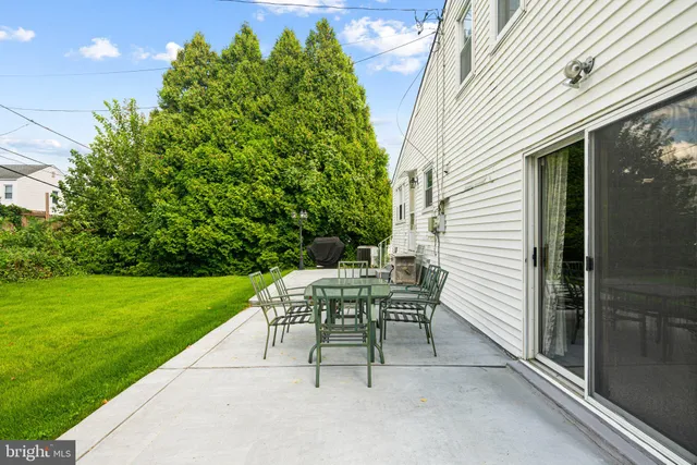 a view of a patio with a table and chairs and potted plants