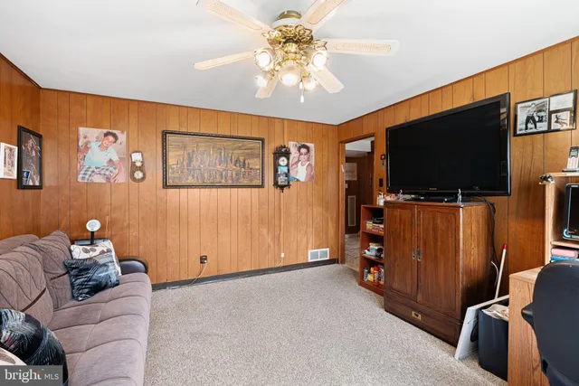 a view of a livingroom with furniture and a flat screen tv